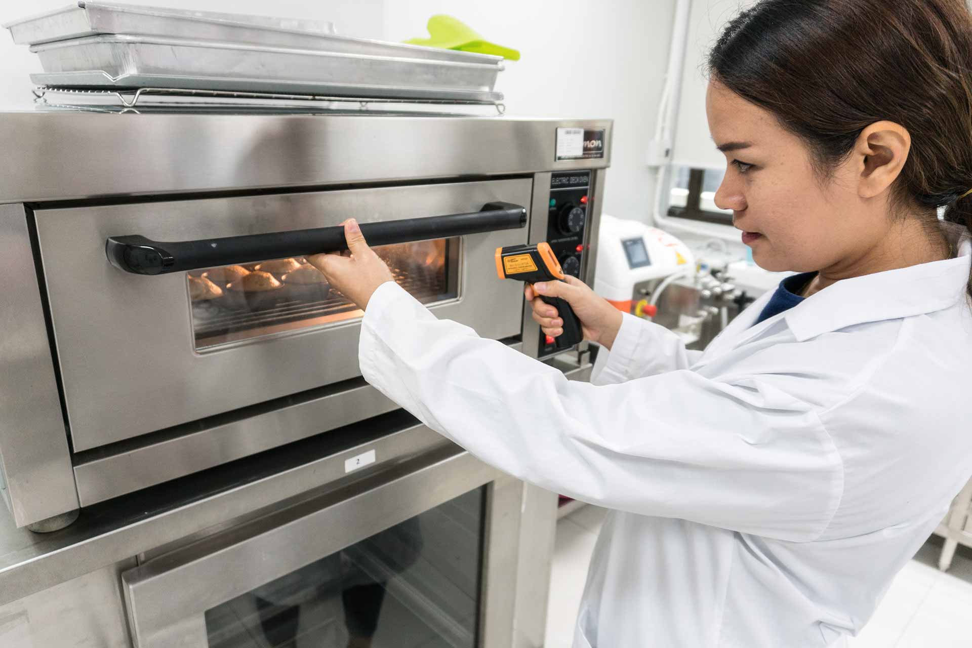 food lab technician checking baked goods with equipment