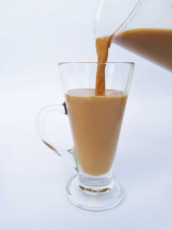 pouring everday milk tea into a glass