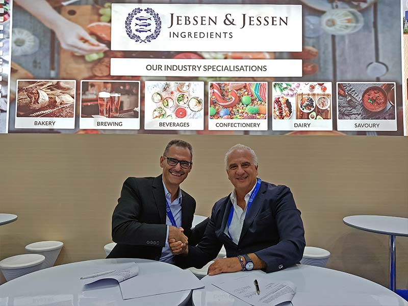 Jebsen and Jessen Ingredients and Sacco management shaking hands after signing contract
