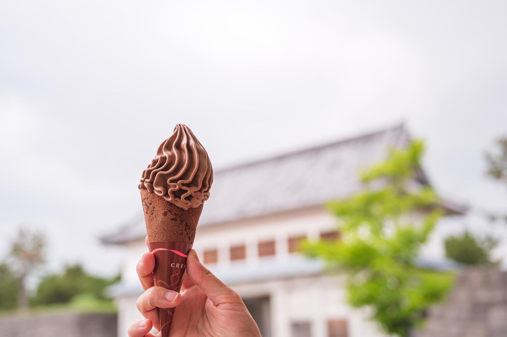 Woman outdoor  at summer sunset time having ice cream cone positive happy playful at city street