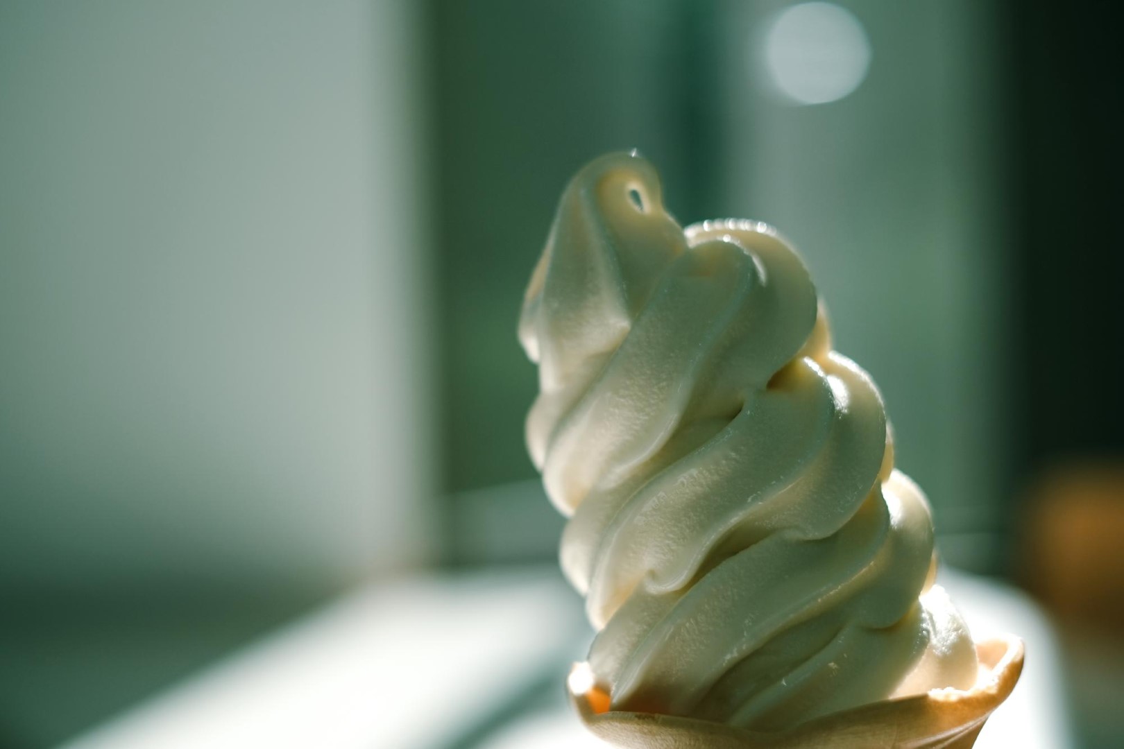 Woman outdoor  at summer sunset time having ice cream cone positive happy playful at city street